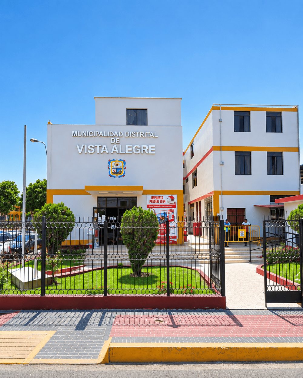 Fachada principal del local municipal de Vista Alegre, con el escudo del distrito sobre la entrada